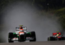 Adrian Sutil leads Sergio Perez in the wet