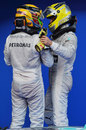 Nico Rosberg and Lewis Hamilton chat in parc ferme