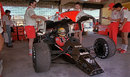 Mechanics replace the bodywork after working on Ayrton Senna's car