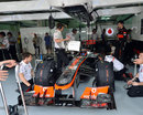 Jenson Button waits patiently in the McLaren garage