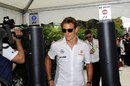 Jenson Button arrives in the paddock on Thursday
