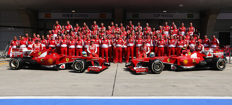 Ferrari pose for a team photo in the pit lane