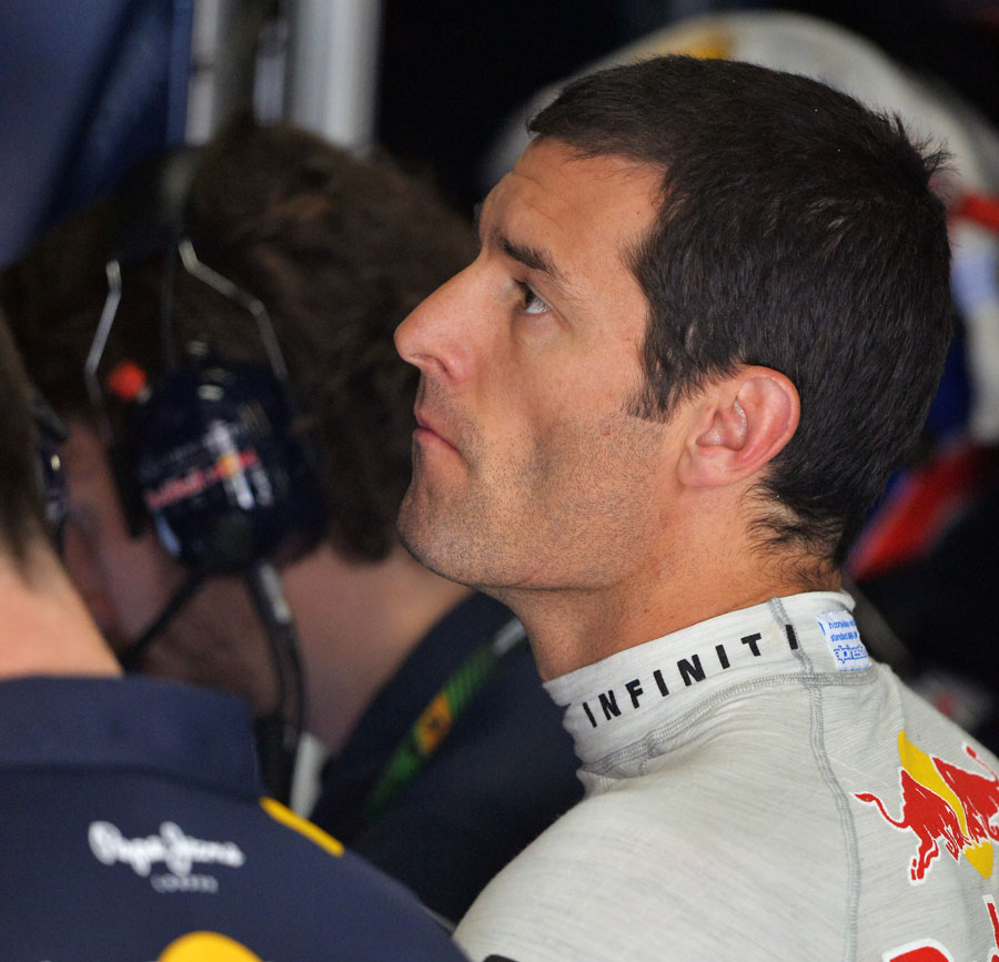 Mark Webber analyses data in the garage