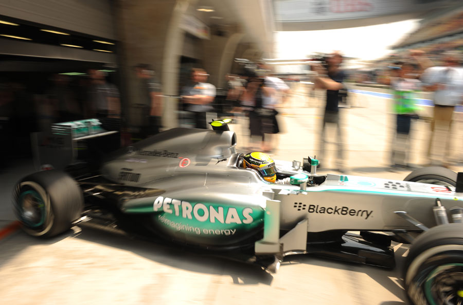 Lewis Hamilton leaves the Mercedes garage on medium tyres