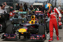 Fernando Alonso inspects Sebastian Vettel's Red Bull in parc ferme