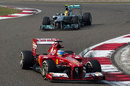 Fernando Alonso heads Lewis Hamilton in to turn two