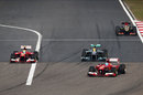 Felipe Massa follows Fernando Alonso past Lewis Hamilton