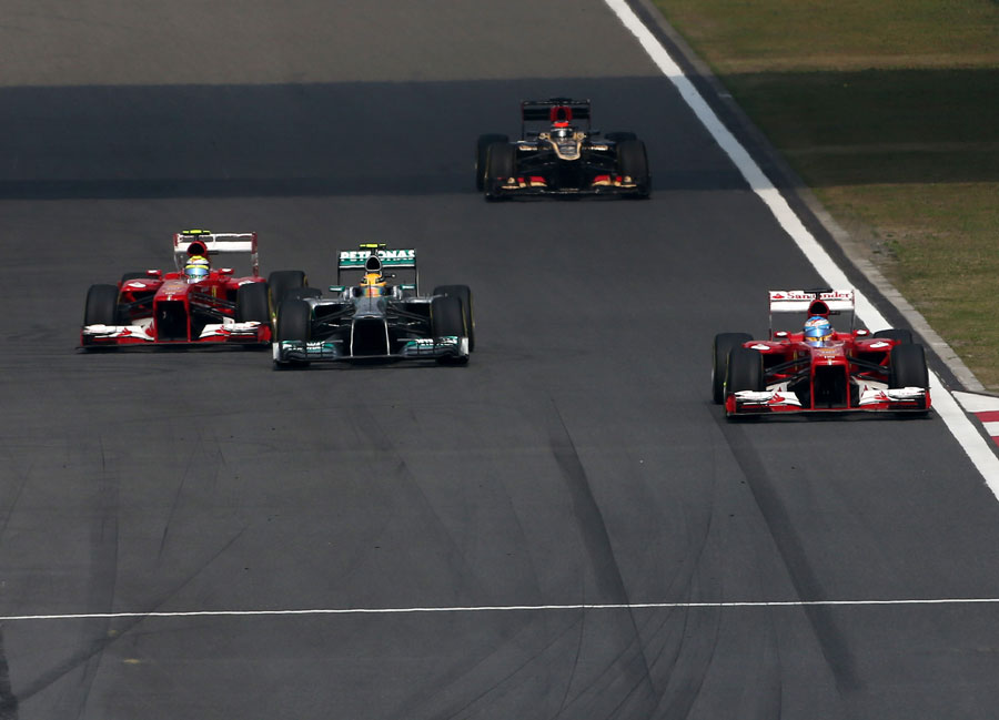 Lewis Hamilton attempts to keep Felipe Massa at bay after being passed by Fernando Alonso