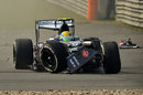 Esteban Gutierrez sits in his wrecked Sauber after hitting Adrian Sutil