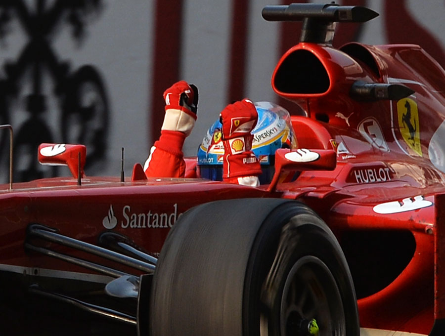 Fernando Alonso celebrates as he crosses the line