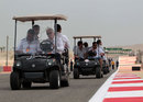 FIA safety delegate Charlie Whiting inspects the track in a golf buggy