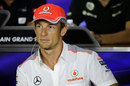 Jenson Button listens intently during the driver press conference