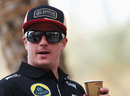 Kimi Raikkonen enjoys a drink in the paddock