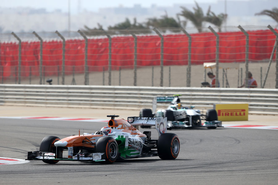 Paul di Resta leads Lewis Hamilton in to Turn 4