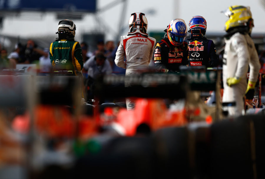 Drivers climb out of their cars in parc ferme