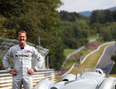 Michael Schumacher poses next to a Mercedes W196 streamliner 