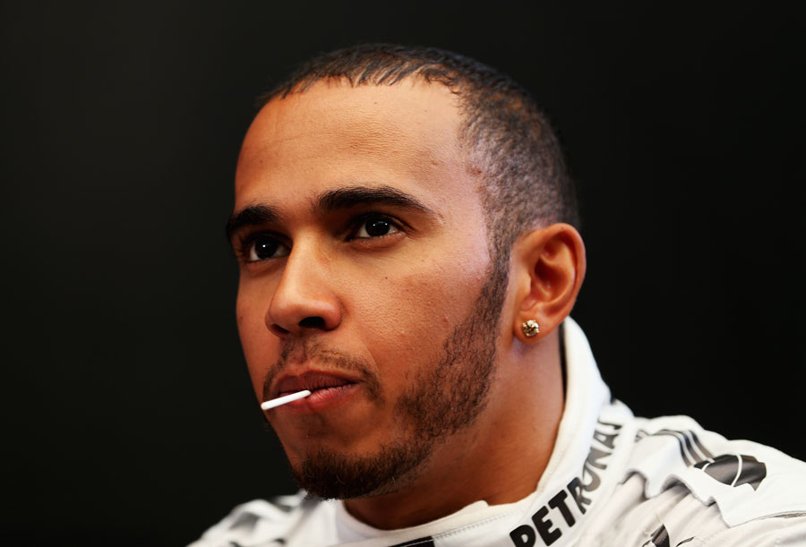 Lewis Hamilton sucks on a lollipop