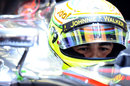 Sergio Perez waits in the cockpit of his McLaren
