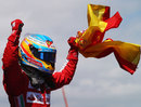 Fernando Alonso celebrates with a Spanish flag
