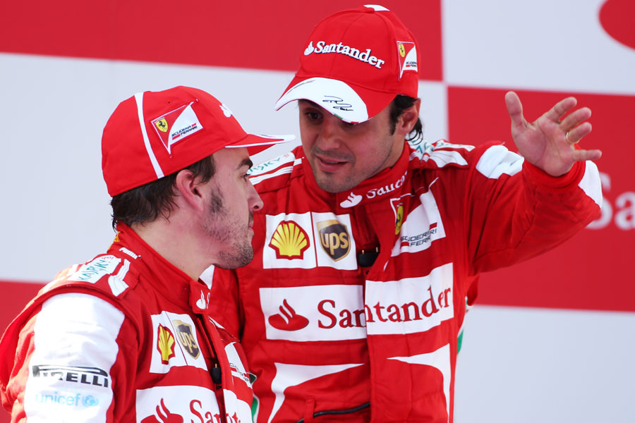 Felipe Massa talks with Fernando Alonso on the podium