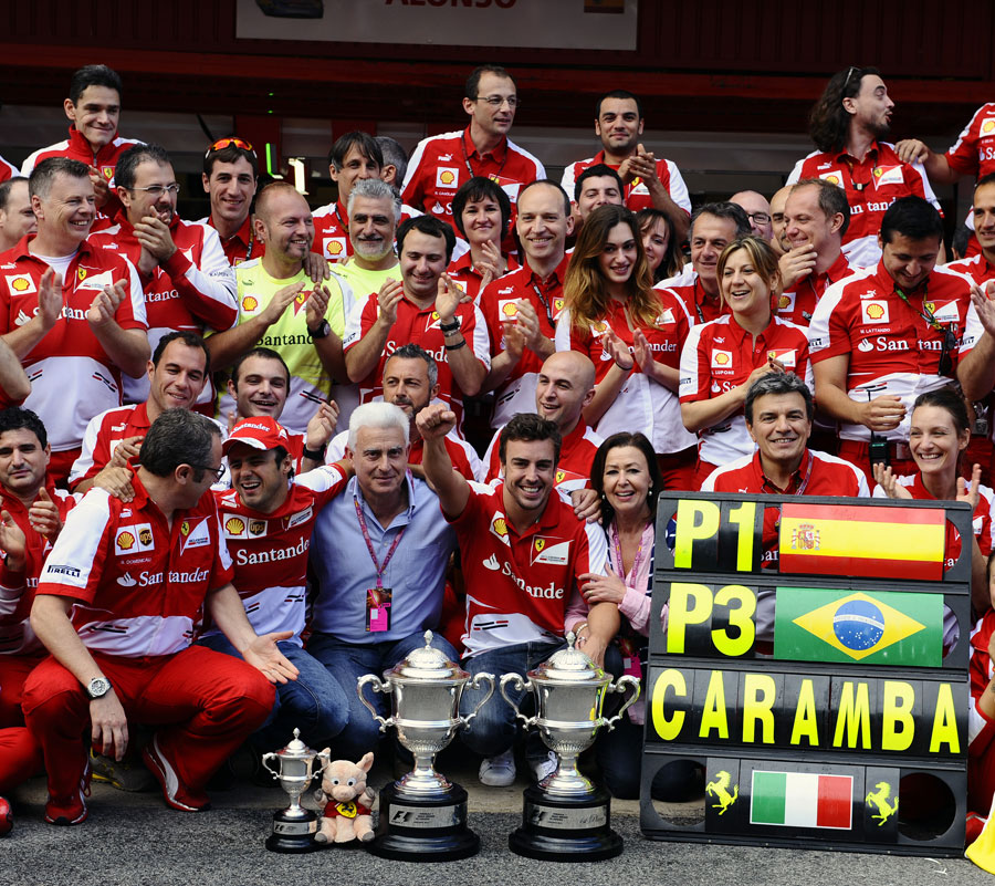 Fernando Alonso celebrates with the Ferrari team and his mother and father