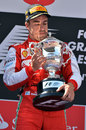 Fernando Alonso admires his winner's trophy