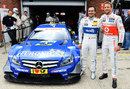 Jenson Button poses before driving Gary Paffett's DTM car