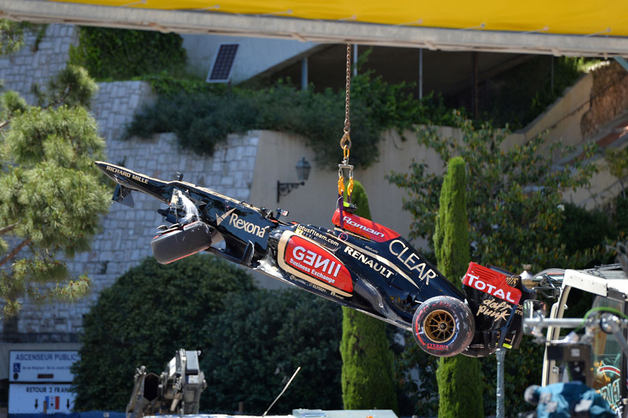Romain Grosjean's damaged Lotus is craned away