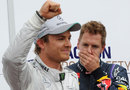 Nico Rosberg celebrates taking pole position ahead of Sebastian Vettel