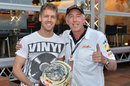 Sebastian Vettel poses with Keith Sutton and his special Monaco helmet with photos from Sutton Images