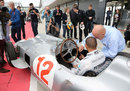 Sir Stirling Moss shows Lewis Hamiltonthe controls of his Mercedes W196