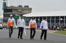 Adrian Sutil walks the track with his Force India team