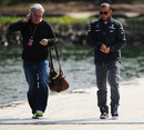 Lewis Hamilton walks to the paddock with his manager Tom Shine