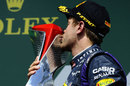 Sebastian Vettel kisses his winner's trophy on the podium