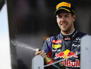 Sebastian Vettel sprays champagne on the podium