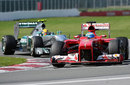Fernando Alonso leads Lewis Hamilton through turn two