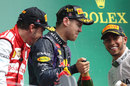 Sebastian Vettel gets soaked in champagne on the podium