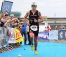 Jenson Button crosses the finish line during the Ironman 70.3 in Berlin
