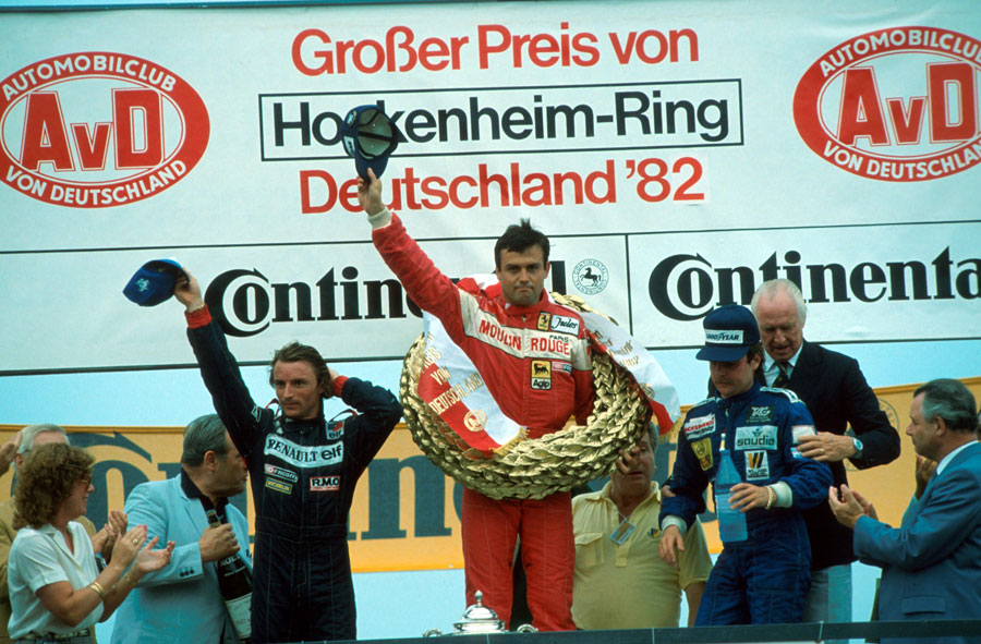 Patrick Tambay celebrates on the podium alongside Rene Arnoux and Keke Rosberg