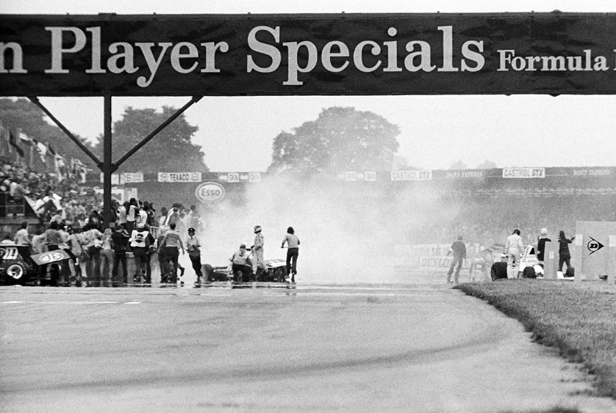 Marshals attend to a huge accident on the first lap of the race caused by Jody Scheckter