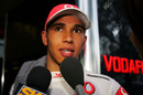 Lewis Hamilton is interviewed by the media after his controversial race finish