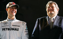 Michael Schumacher and Norbert Haug share a joke