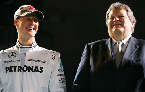 Michael Schumacher and Norbert Haug share a joke
