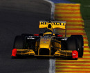 Robert Kubica leans on the kerbing in the Renault
