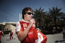 Ferrari's Spanish driver Fernando Alonso relaxes in the Bahrain paddock