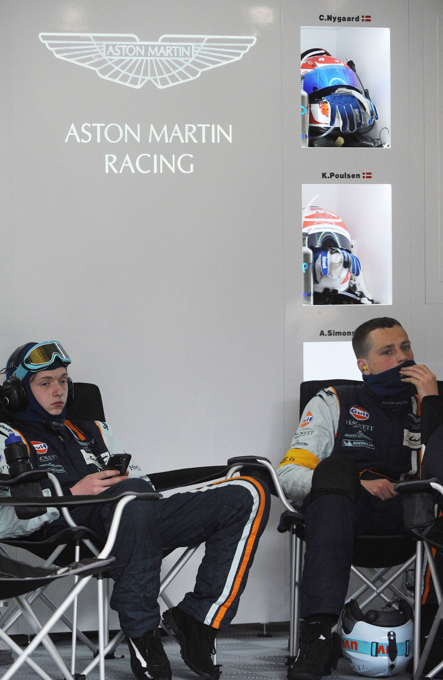 Aston Martin mechanics sit shocked after Allan Simonsen died after crashing into safety barriers