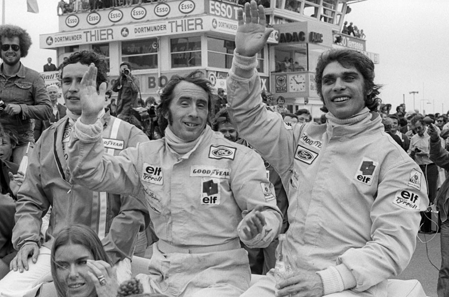 Jackie Stewart and Francois Cevert wave to the crowd on their victory parade after taking a one-two for Tyrrell