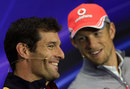 Mark Webber and Jenson Button share a joke during the driver press conference