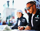 Lewis Hamilton and Nico Rosberg sign autographs