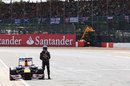 Sebastian Vettel stands by his stricken Red Bull
